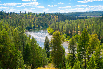 A section of rapids along the Spokane River seen from the Audubon Downriver bluff near downtown Spokane, Washington, USA at summer.