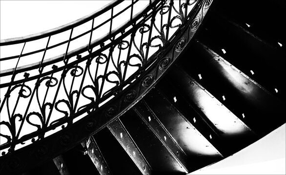 Infinite dark black and white stairs going up and up.