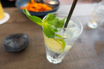 Lemonade with fresh lemon on wooden table background