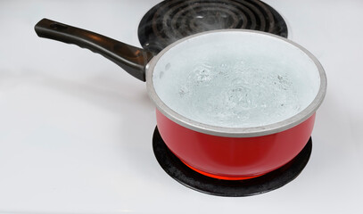 Red Pan of Boiling Water On Stove Top With Copy Space