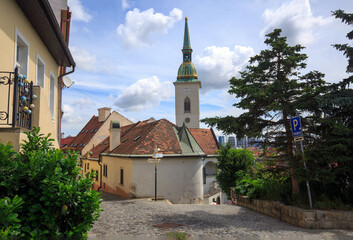 Old Cobbled Street in Bratislava with the steeple of St Martins Church in the centre.