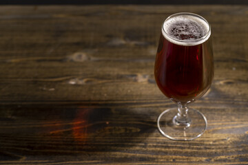 dark beer in a glass glass, fresh dark alcoholic beer