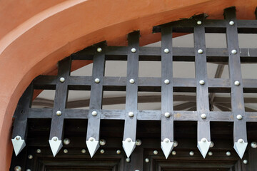 Historic and ornate gate. We see a wooden structure.