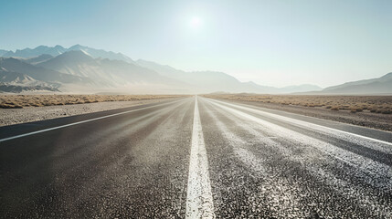 Fototapeta premium Background of an empty highway stretching into the distance through a desert landscape under a clear sky