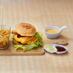 Exquisite burger with french fries and vegetables