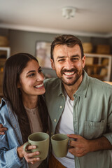 Portrait of boyfriend and girlfriend drink coffee and enjoy at home