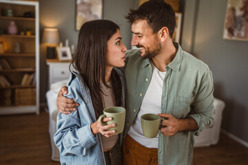Portrait of boyfriend and girlfriend drink coffee and enjoy at home