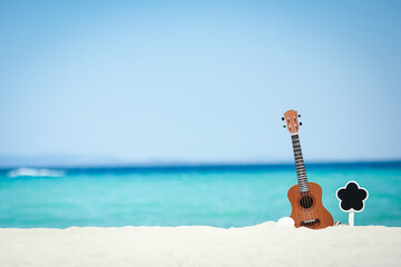 A beautiful guitar on the sand by the Greek sea