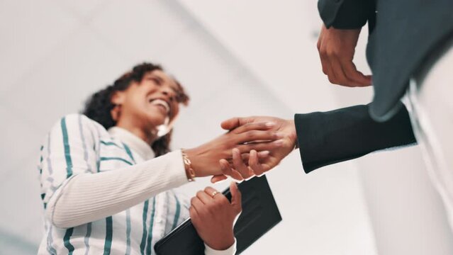 Handshake, deal and business people in office with agreement, partnership or company merger. Welcome, greeting and low angle of hr with hiring candidate for onboarding shaking hands in workplace.