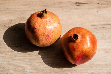 Ripe pomegranate fruit closeup on wooden background