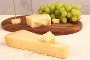Pieces of tasty Parmesan cheese on table