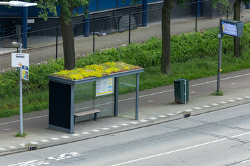 Modern bus stop with roof garden and Bus Stop sign with LED Display destination Utrecht Central Station. © PixelBiss
