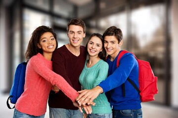 Group of a happy young friends students standing together