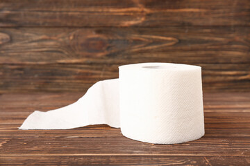 Roll of toilet paper on wooden background