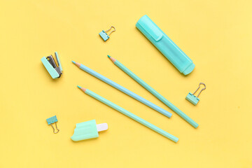 Set of different stationery with pencils on yellow background