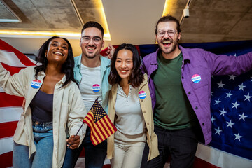 A diverse group of people stands proudly together, each holding a small American flag in one hand...