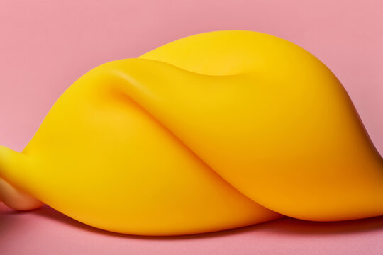Squishy anti stress toy in yellow tone with soft curves in pink studio