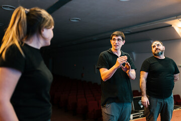 Group of colleagues discussing work strategy in auditorium