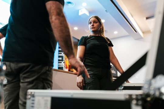 Technicians talking while preparing for music concert