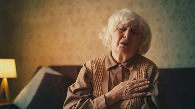 Unhappy senior woman suffering from strong chest pain, risk of heart attack