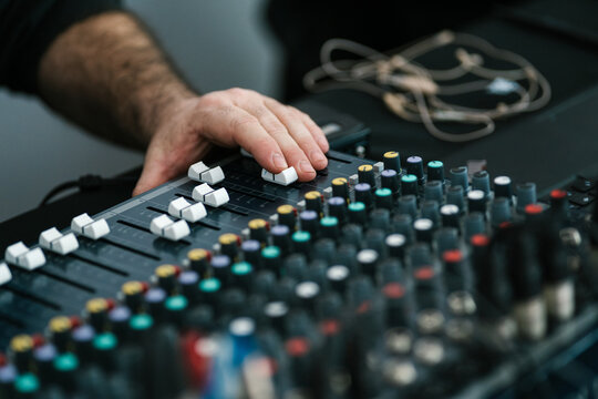 Unrecognizable man with finger on fader