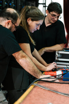 Technicians using netbook in backstage at music concert