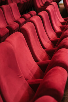 Row of empty red chairs in auditorium