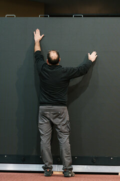 Anonymous technician touching and checking LED video wall
