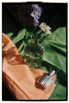 A bottle of perfume and flowers.