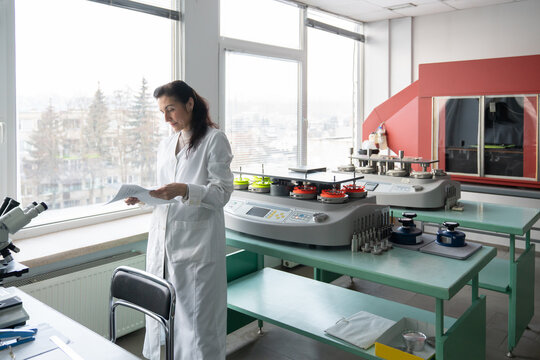 Researcher Reading Documents In The Lab