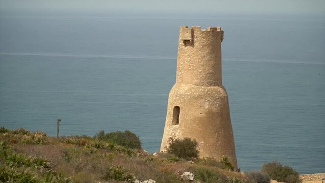 Slow motion, beautiful landscape with a historic watchtower on background, in Torre del Gerro, D&eacute;nia (Alicante ,Spain)