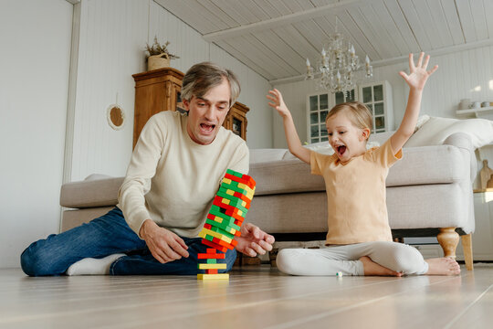 Father and daughter playing with blocks game