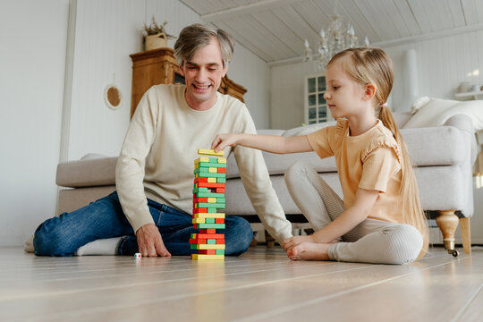 Father and daughter playing Jenga