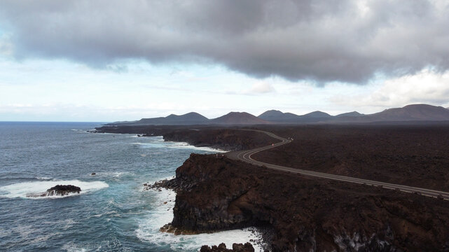 road between lava and the edge of the sea from drone view