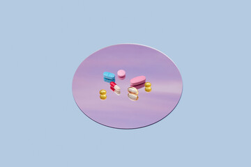 Variation of pills of different colours located on lavender