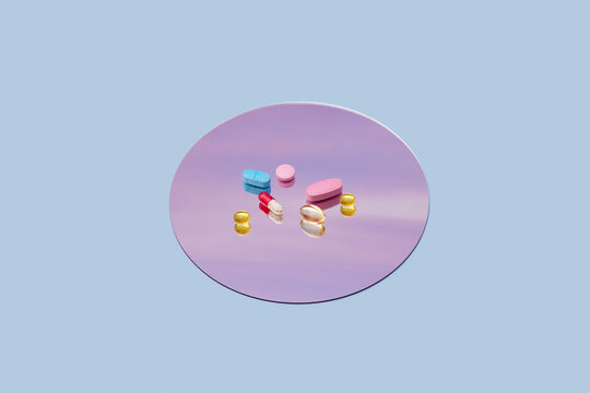 Variation of pills of different colours located on lavender