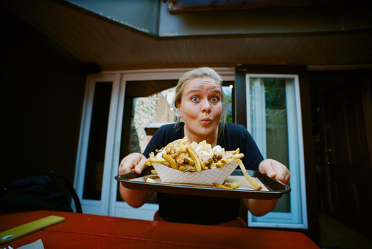 Woman holding a poutine 