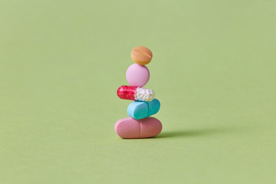 Five various tablets in vertical row isolated on studio background