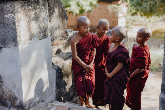 Group of novice monks chatting in temple grounds