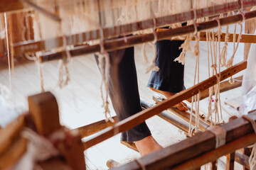 Detailed Weaving Process on a Wooden Loom