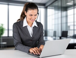Fototapeta premium Portrait of a smiling business woman at desk in office