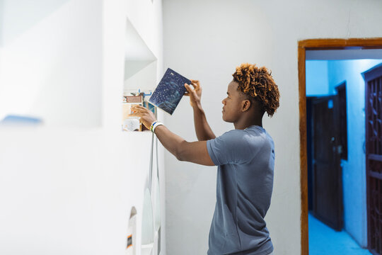 Man Placing Photo on Shelf on library