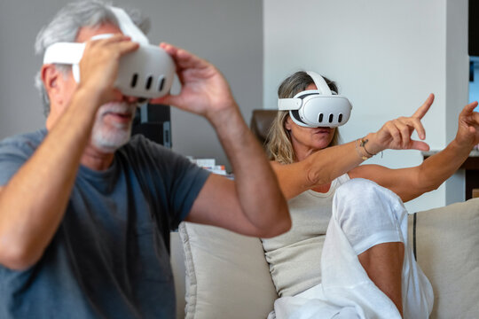 Senior couple playing on VR headset 