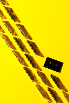Cassette tapes aligned on yellow background