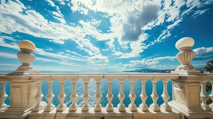 a white marble balcony with railings against the backdrop of a pristine blue sky and sea, adorned with fluffy white clouds, overlooking the expansive ocean.