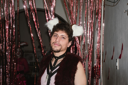 Young queer man in a furry party