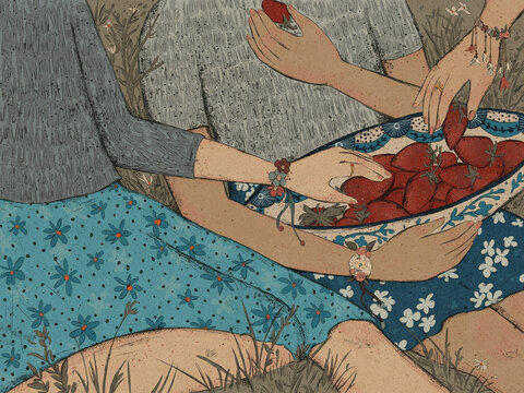 Girls eat strawberries on a picnic