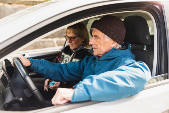 Senior couple sitting inside the car
