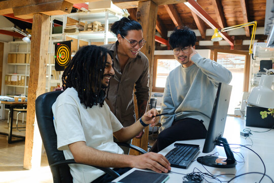 Coworkers in front of computer screen in positive attitude