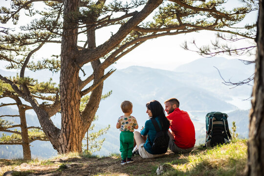 Family resting on a mountain viewpoint